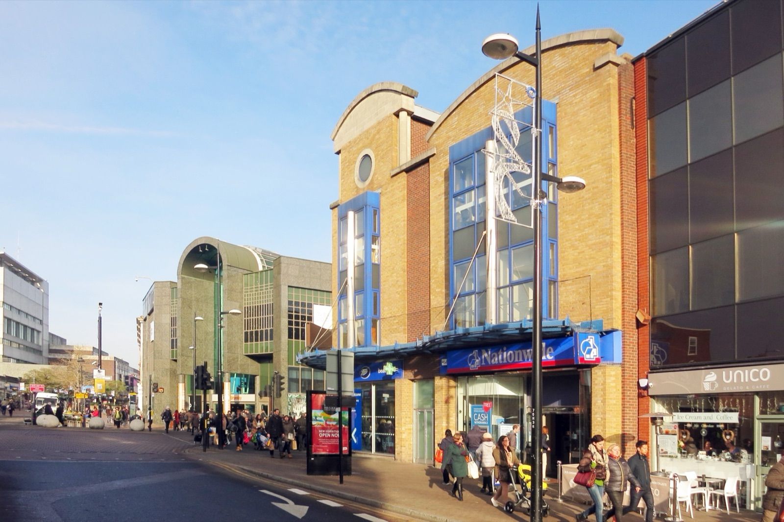 Bromley High Street on a clear day, shoppers on the pavement outside the town-centre shops