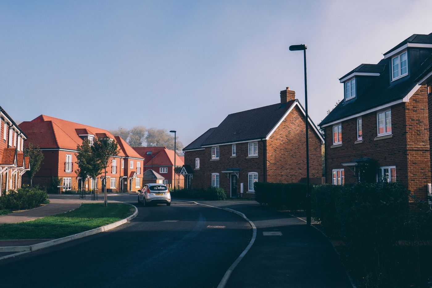 A quiet suburban street of red-brick family houses